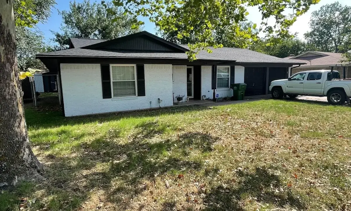 Professional roofing crew working on a residential roof in Freeport